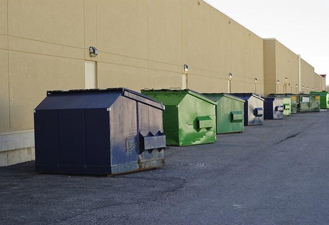 a row of blue construction dumpsters on a job site in Burien